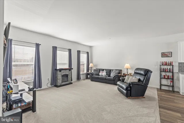 a living room with furniture a large window and book shelf
