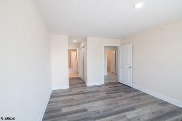 a view of an empty room and wooden floor