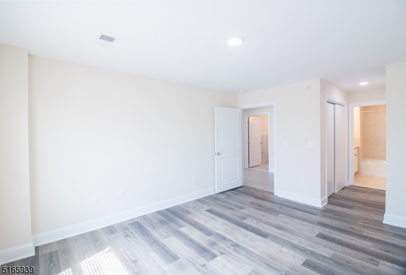 1664 Stuyvesant Avenue, Unit 306 Union, NJ 07083 - Photo 13 of 22 a view of an empty room and wooden floor