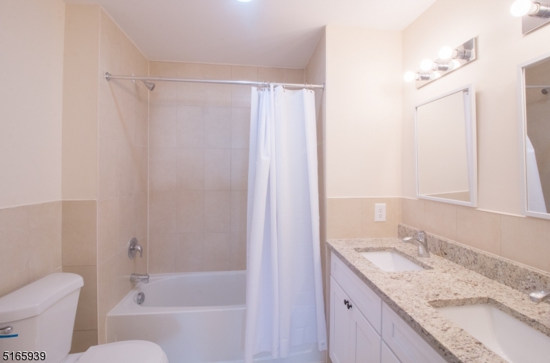 1664 Stuyvesant Avenue, Unit 306 Union, NJ 07083 - Photo 15 of 22 a bathroom with a granite countertop sink toilet and shower