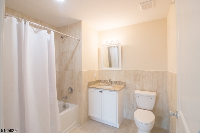 1664 Stuyvesant Avenue, Unit 306 Union, NJ 07083 - Photo 17 of 22 a bathroom with a toilet a sink and a bathtub