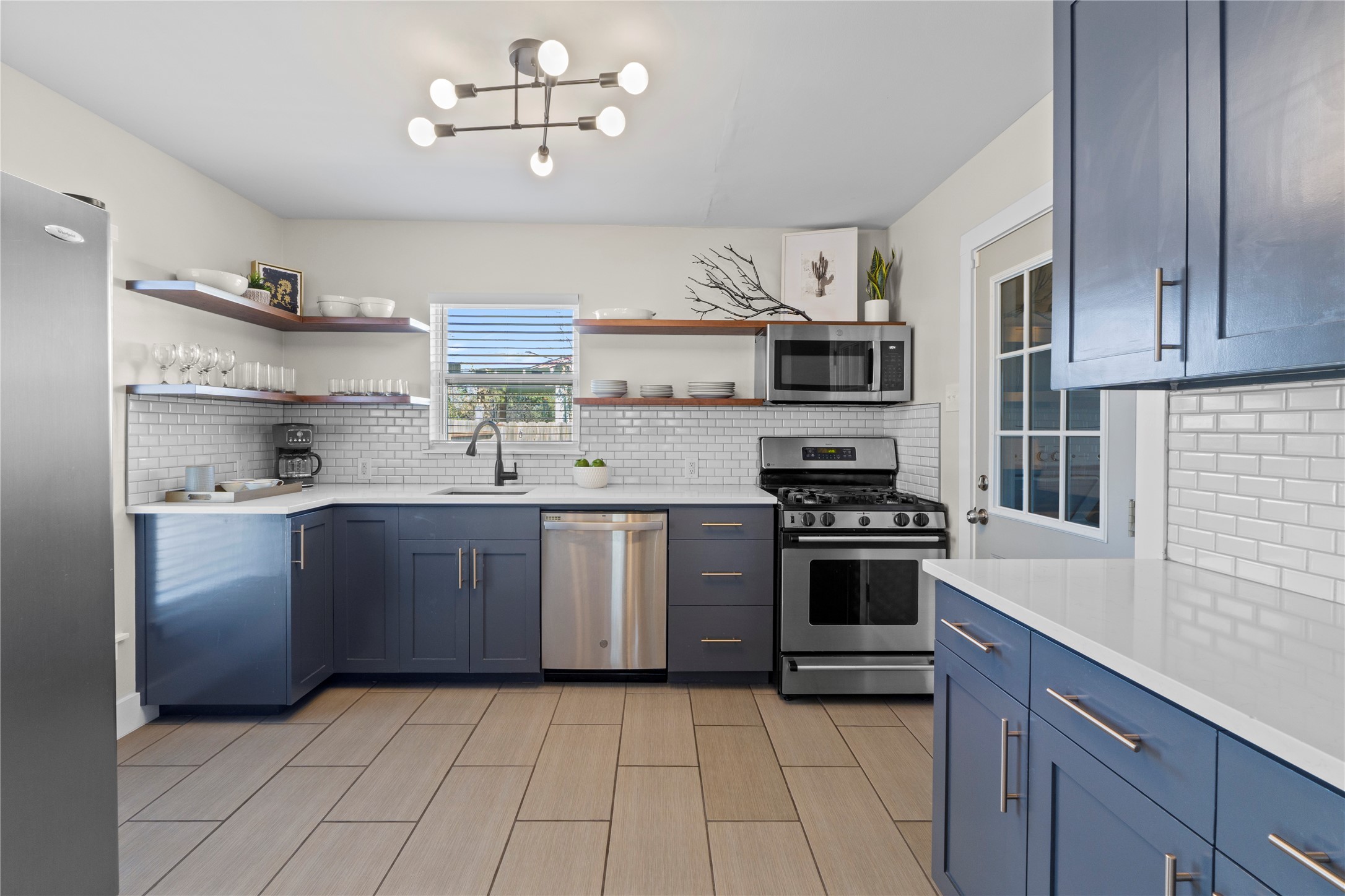 7803 Watson Street Austin, TX 78757 - Photo 11 of 30 Custom cabintry, quartz counters, stainless steel appliances make this kitchen really shine.