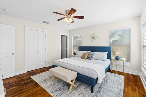 a bedroom with a bed and wooden floor