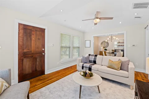 a living room with furniture rug and window