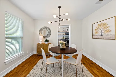 a dining room with furniture and wooden floor