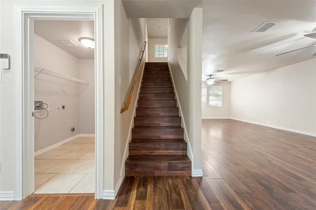 a view of entryway and hall with wooden floor