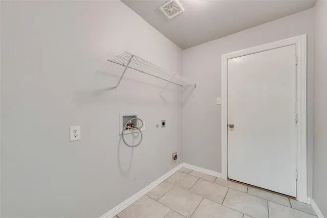 an empty room with wooden floor and a ceiling fan
