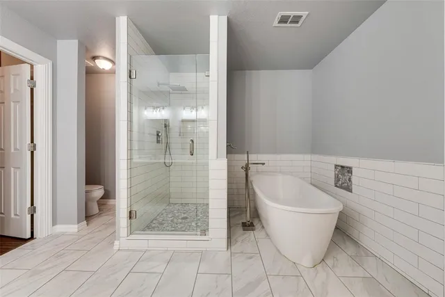a bathroom with a toilet sink double and mirror