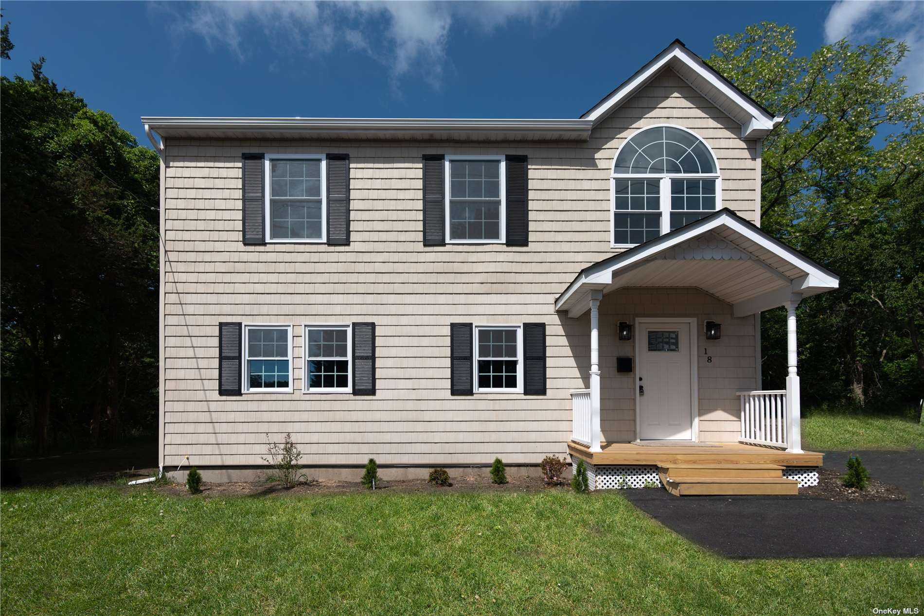 18 Raynor Road Ridge, NY 11961 - Photo 1 of 1 a front view of a house with a yard and trees