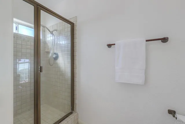 a bathroom with a glass shower door