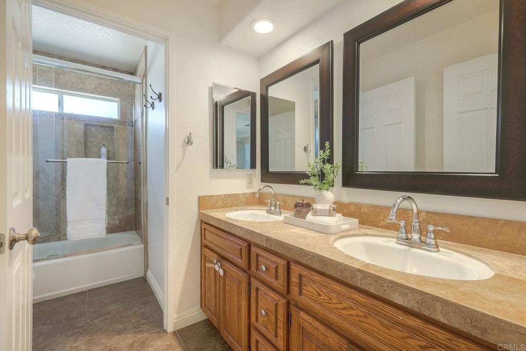 13979 Hickory Street Poway, CA 92064 - Photo 31 of 37 a bathroom with a double vanity sink and a mirror