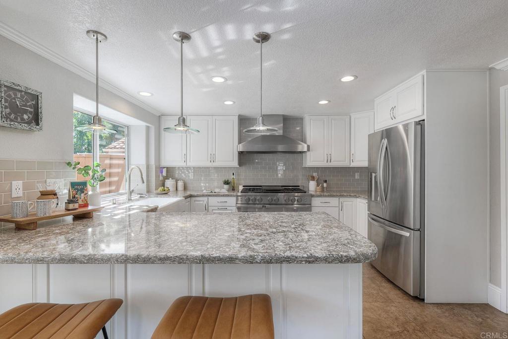 13979 Hickory Street Poway, CA 92064 - Photo 4 of 37 a kitchen with stainless steel appliances granite countertop a refrigerator a sink and a stove