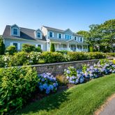 a view of a bunch of flowers in front of house