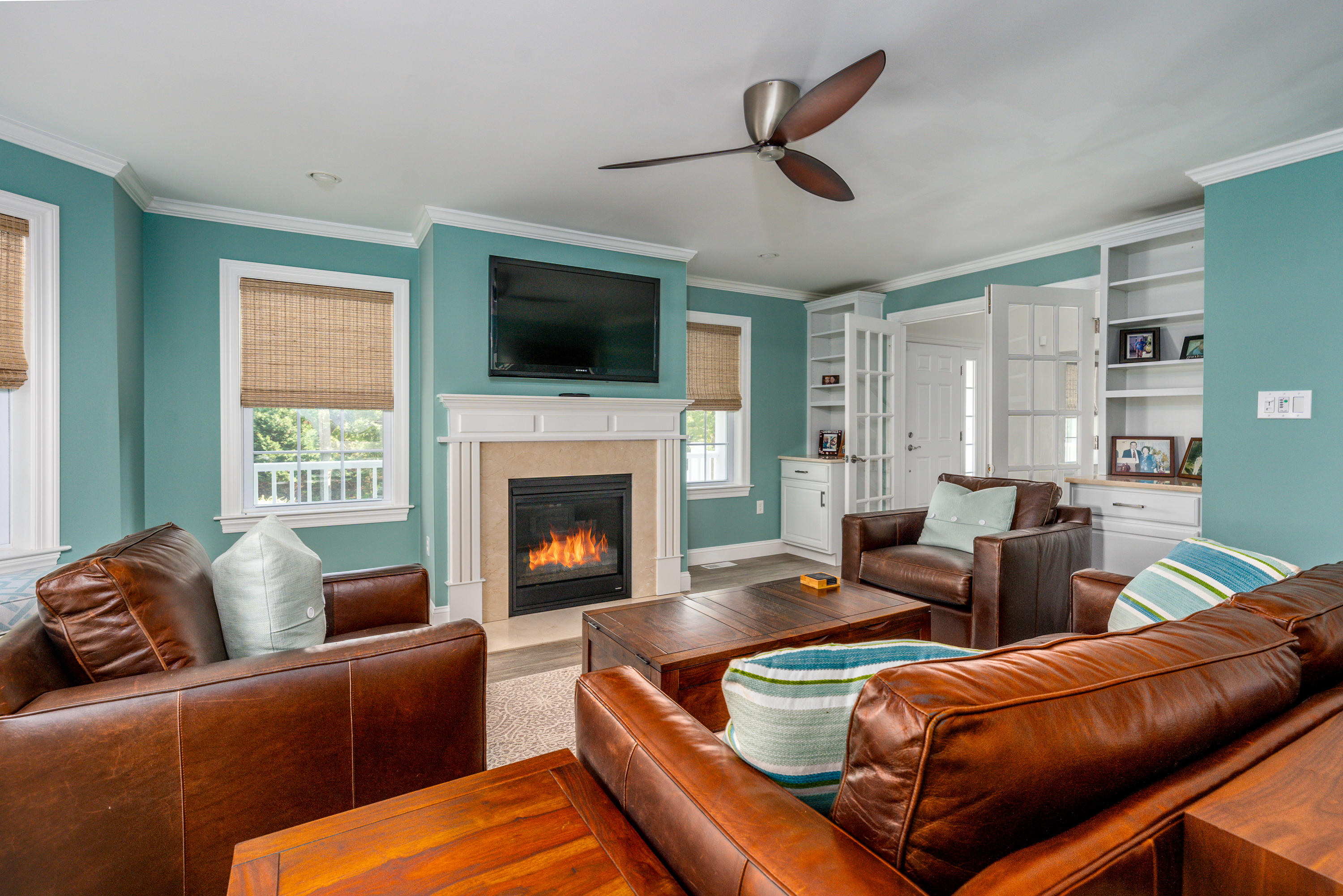 52 Pleasant Bay Road Harwich, MA 02645 - Photo 18 of 43 a living room with furniture a flat screen tv and a fireplace