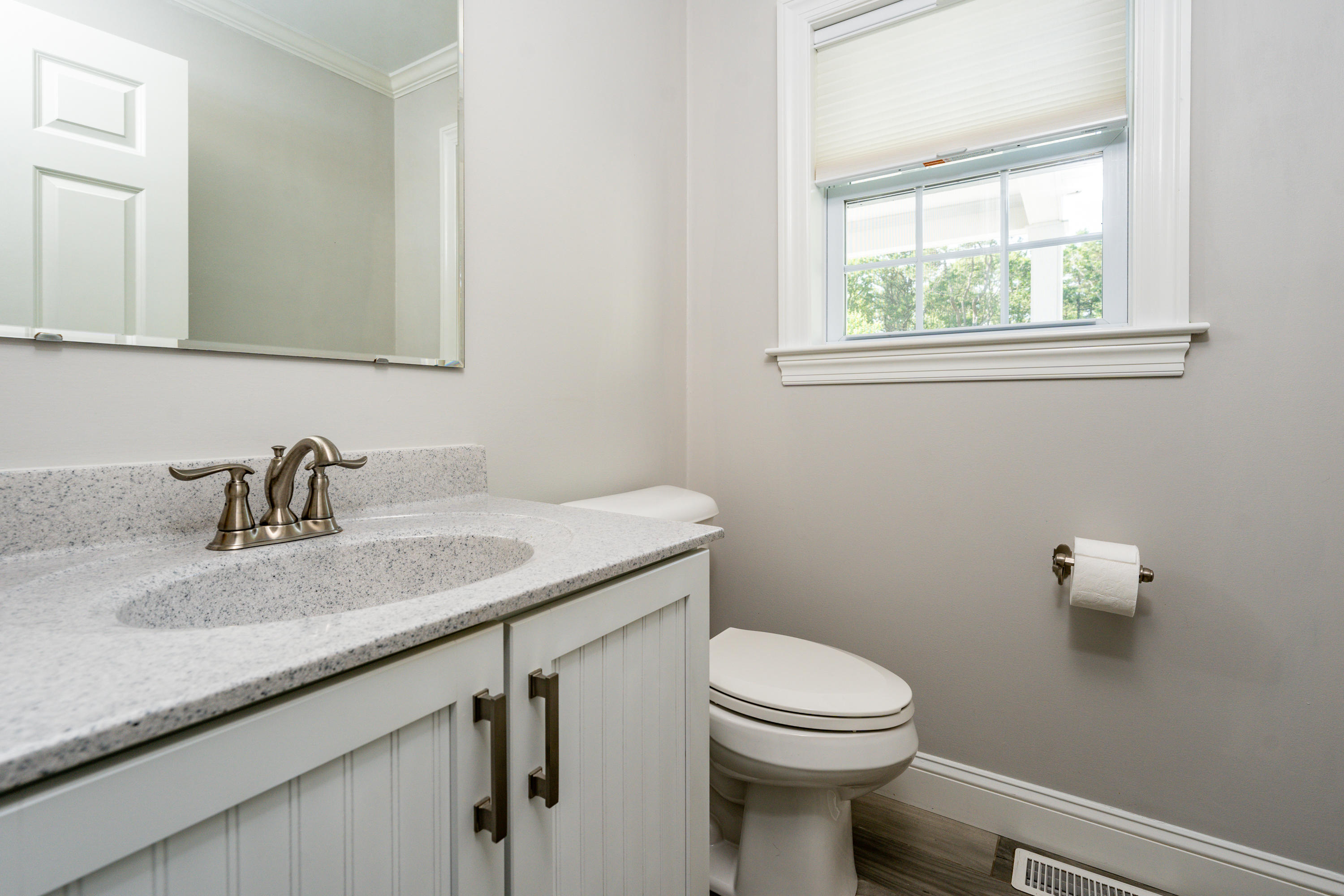 52 Pleasant Bay Road Harwich, MA 02645 - Photo 22 of 43 a bathroom with a granite countertop toilet a sink and a mirror