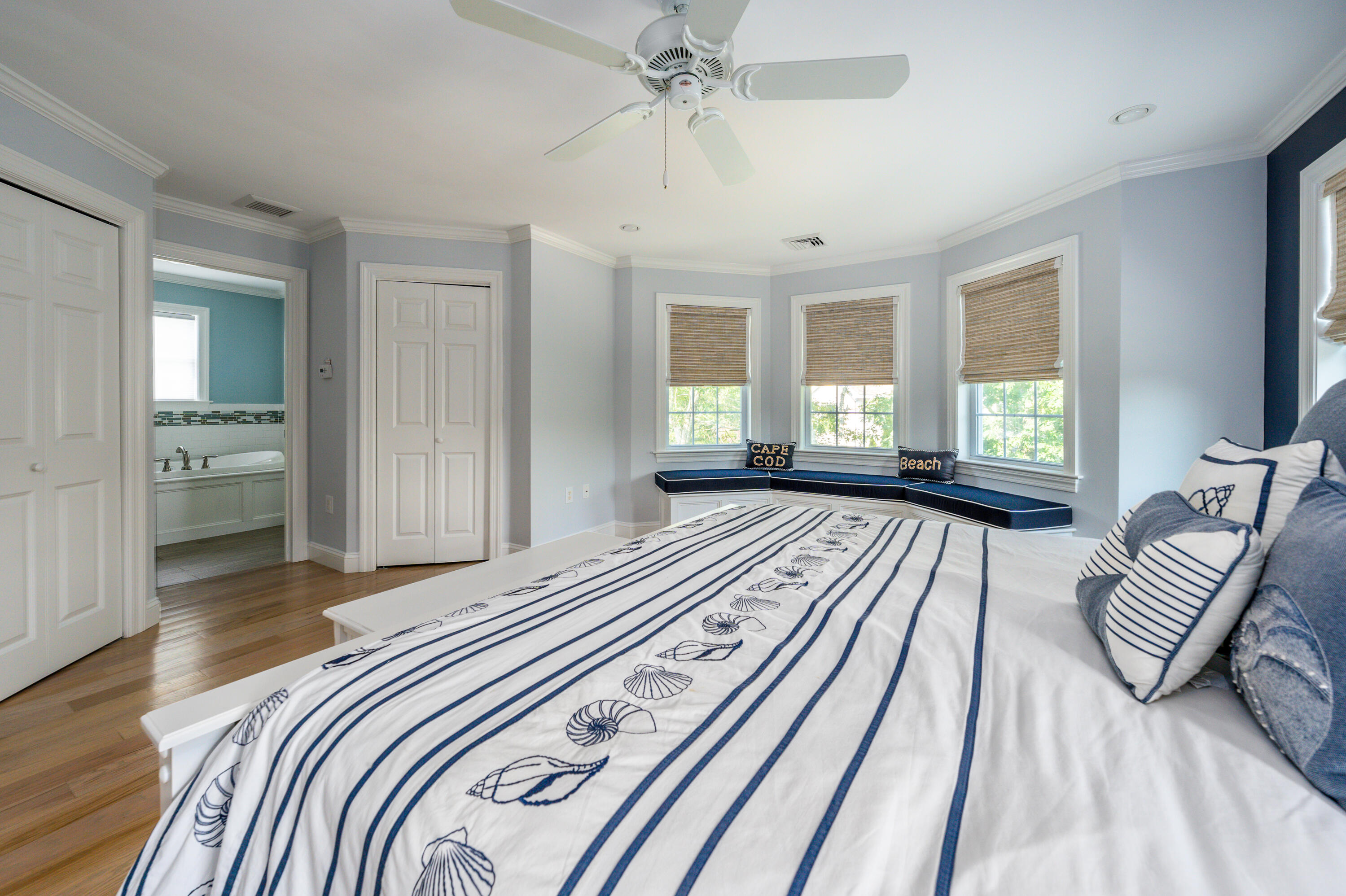52 Pleasant Bay Road Harwich, MA 02645 - Photo 26 of 43 a bedroom with a bed and a chandelier