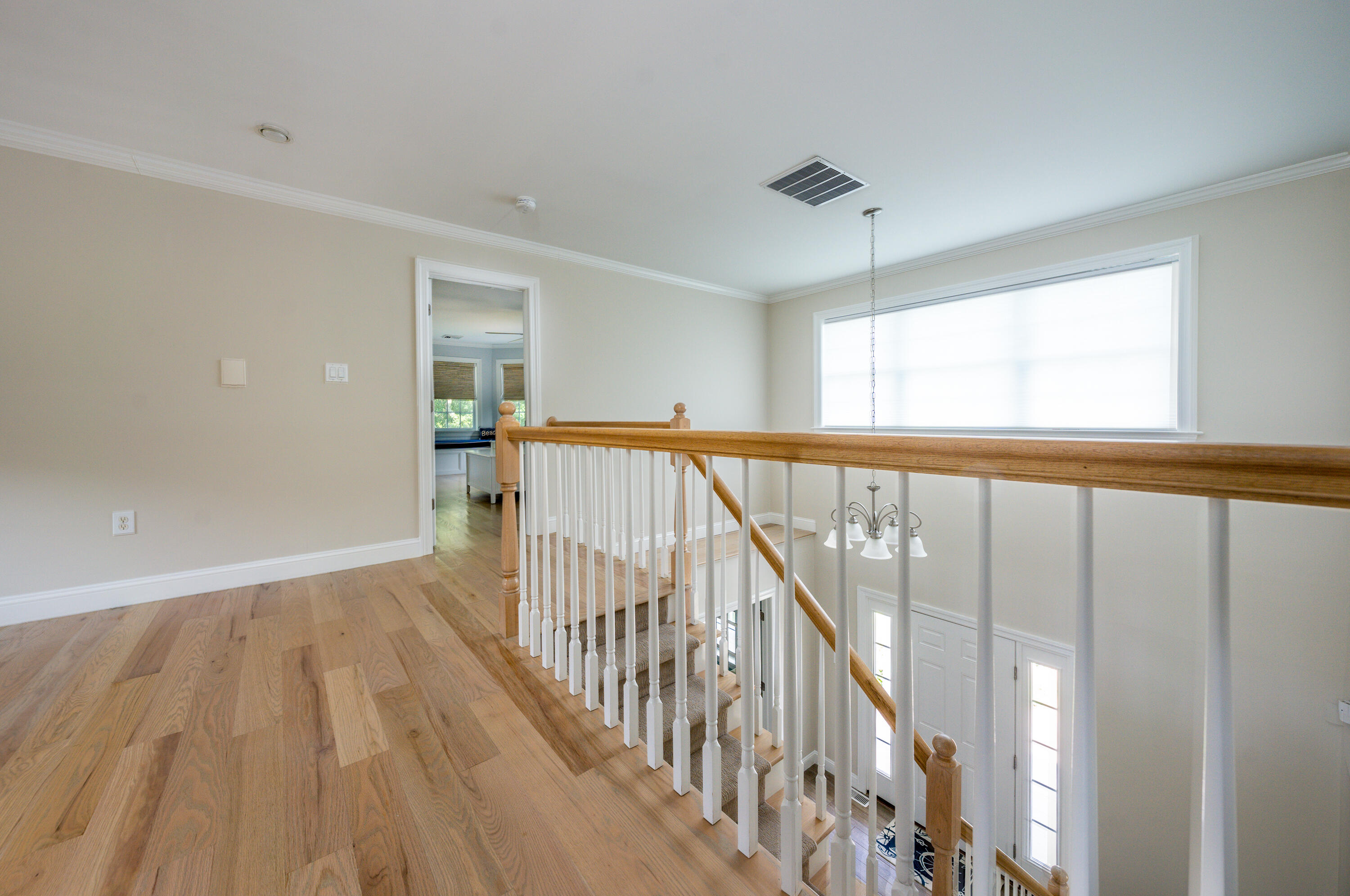 52 Pleasant Bay Road Harwich, MA 02645 - Photo 29 of 43 a view of a hallway with wooden floor and staircase