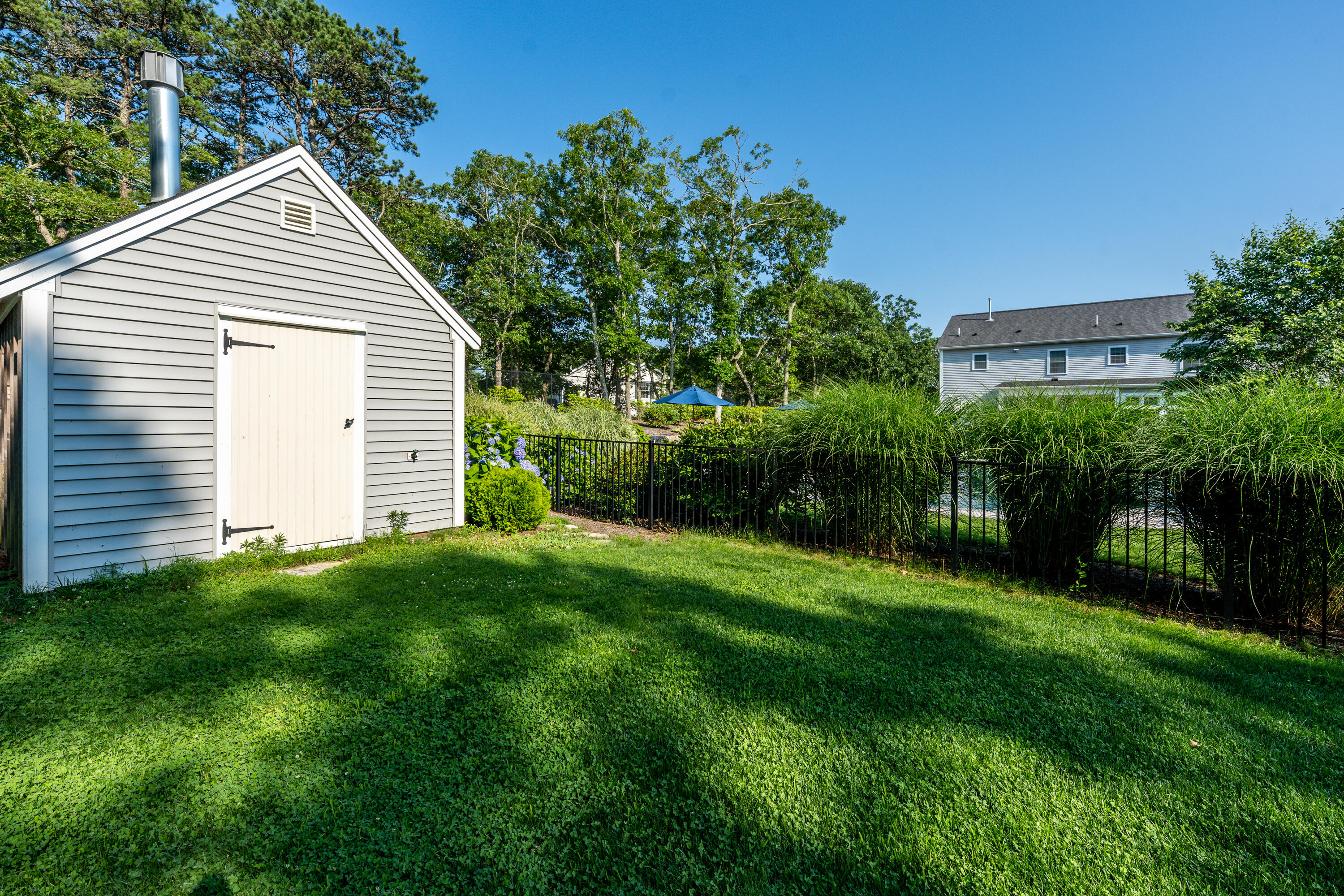 52 Pleasant Bay Road Harwich, MA 02645 - Photo 40 of 43 a view of a backyard with plants and a garden