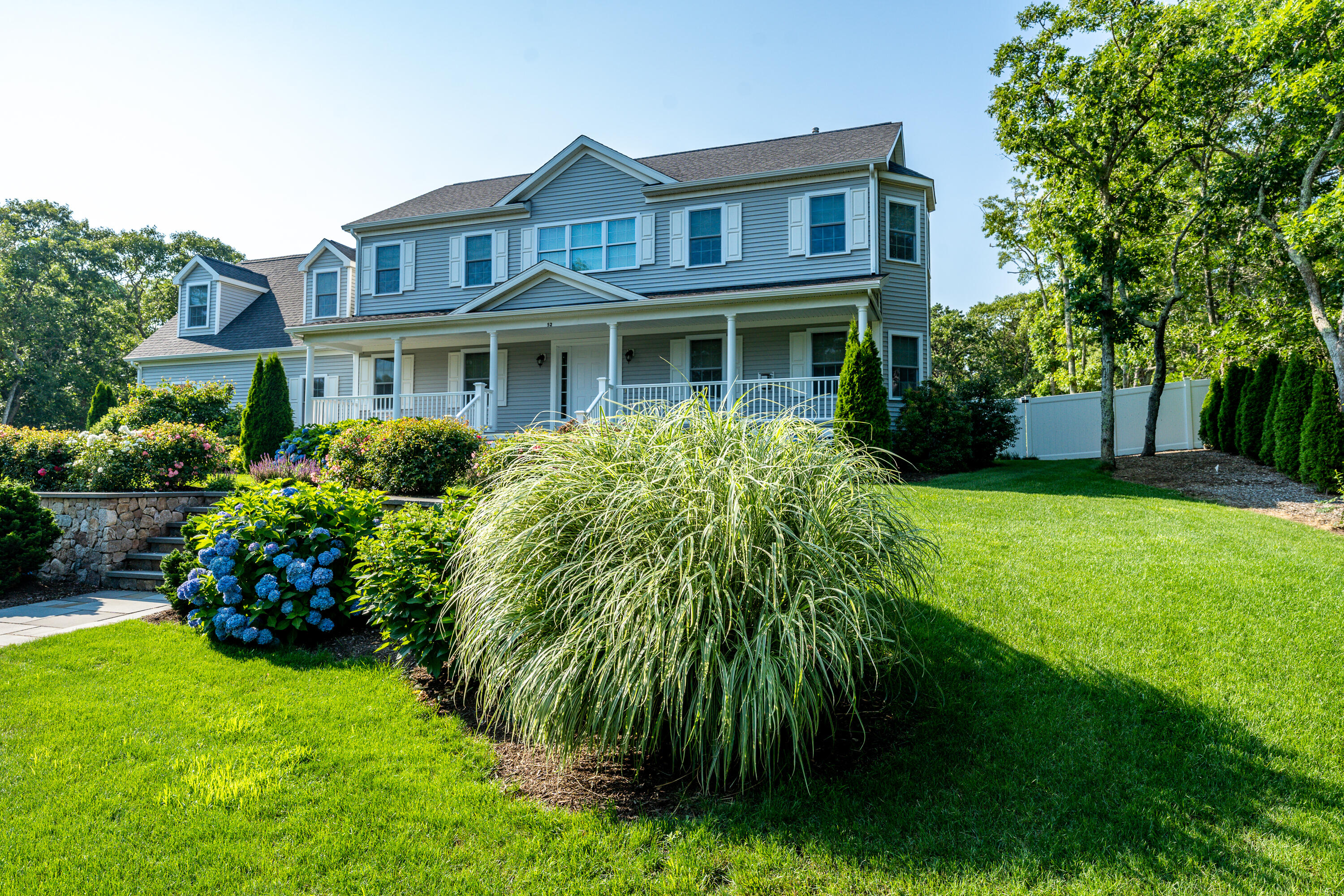 52 Pleasant Bay Road Harwich, MA 02645 - Photo 42 of 43 a front view of a house with a garden