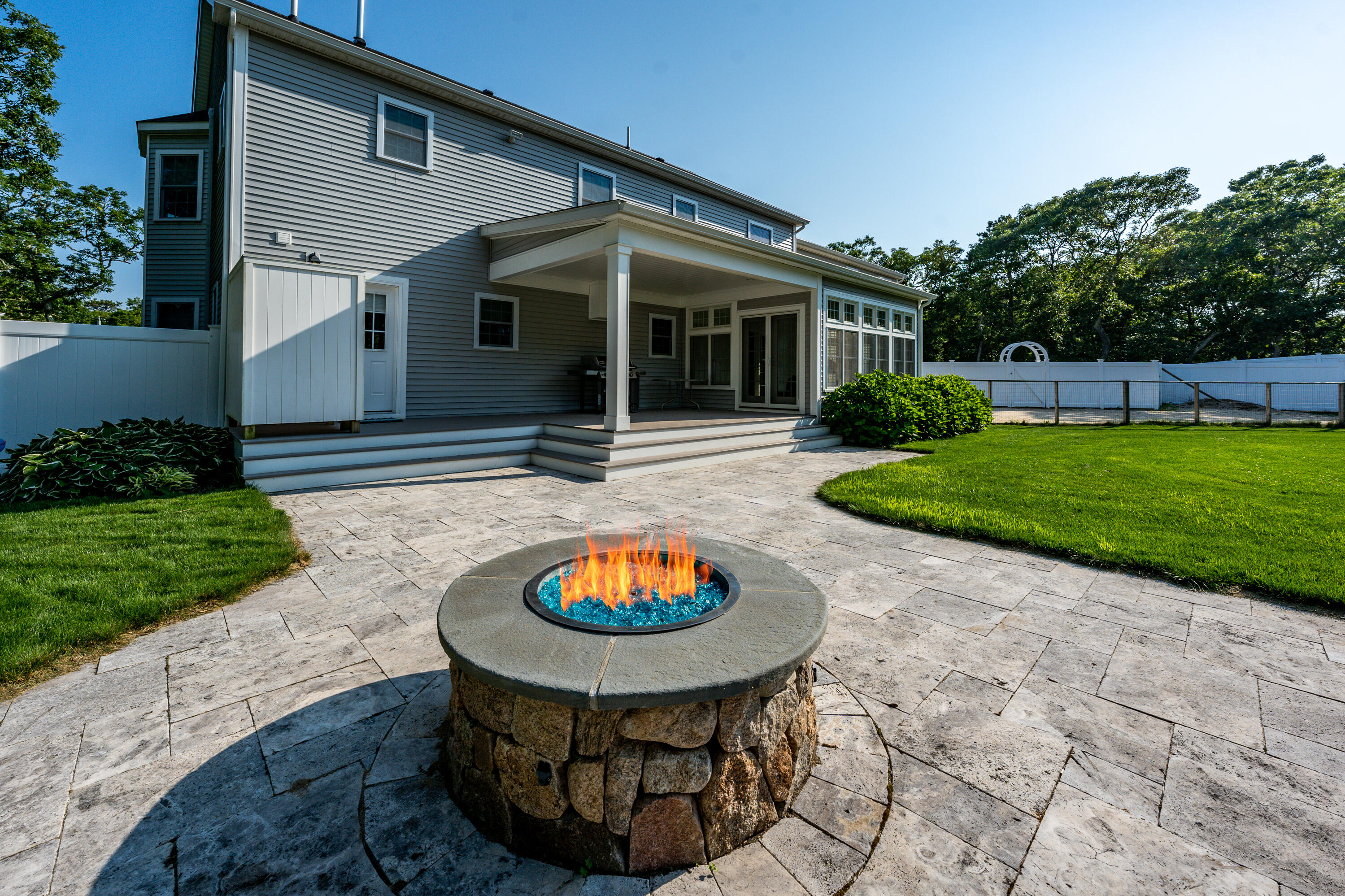 52 Pleasant Bay Road Harwich, MA 02645 - Photo 6 of 43 a view of a white house with a swimming pool and a yard