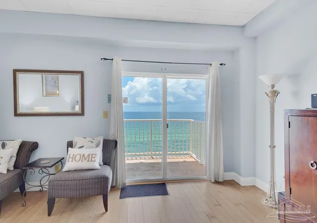 a living room with furniture and a floor to ceiling window