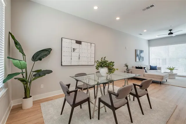 a view of a dining room with furniture and a potted plant
