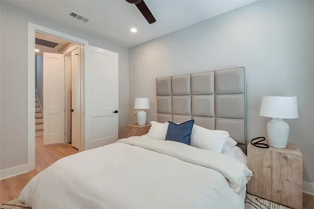 a bedroom with a bed and a lamp