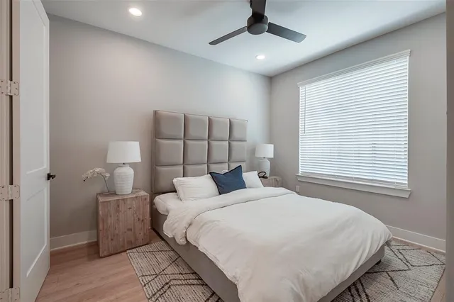 a bedroom with a large bed and a chandelier