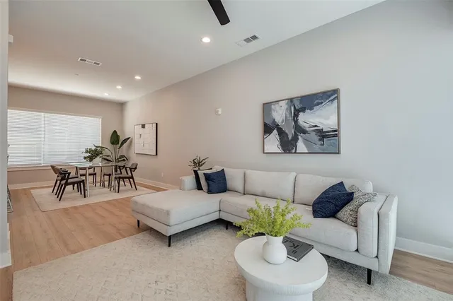 a living room with furniture and white walls