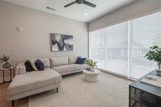a living room with furniture and a potted plant