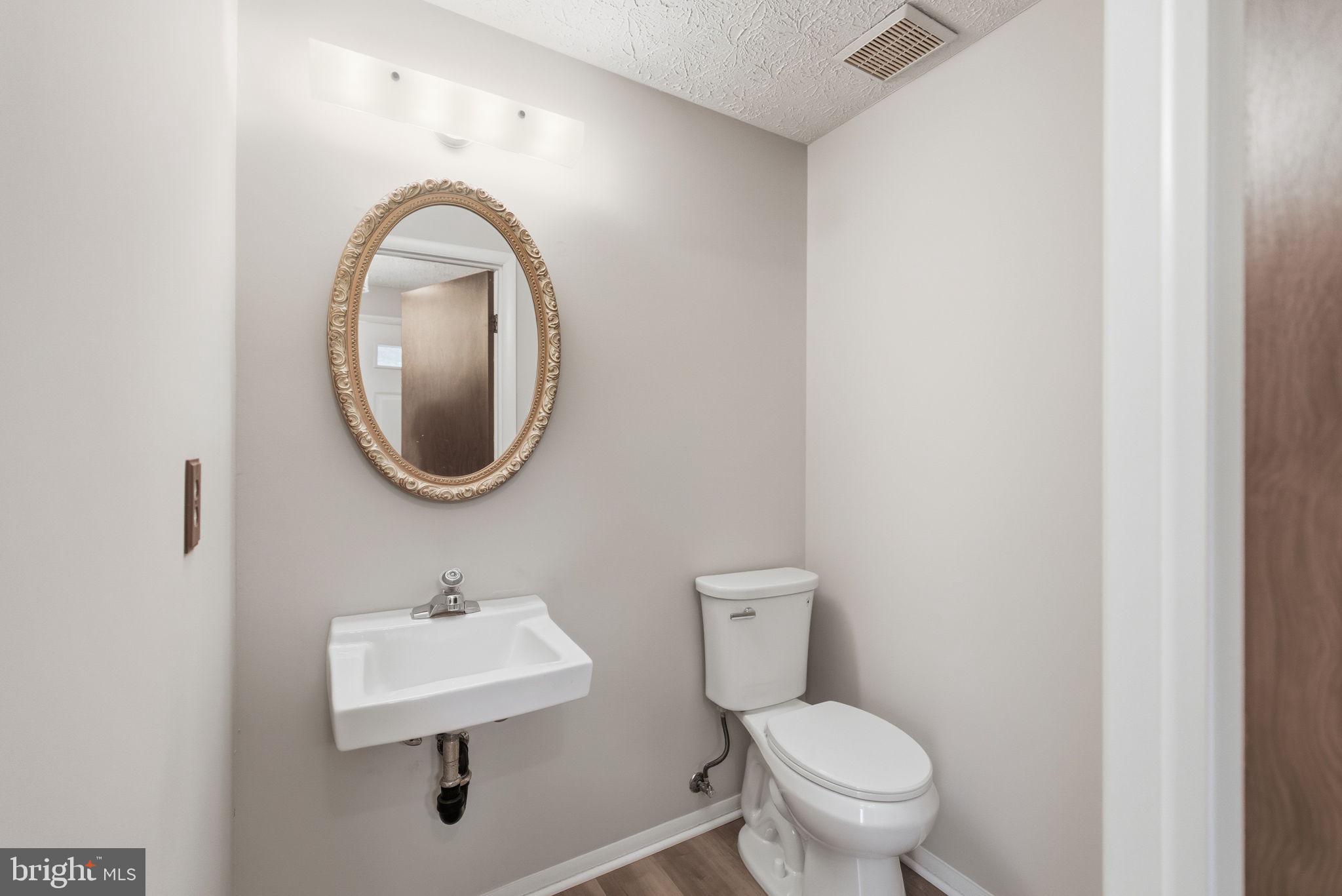 11563 Ivy Bush Court Reston, VA 20191 - Photo 5 of 48 a bathroom with a toilet sink and mirror