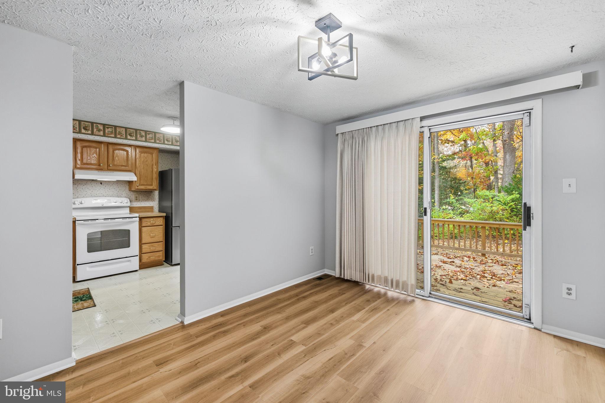 11563 Ivy Bush Court Reston, VA 20191 - Photo 6 of 48 a view of empty room with wooden floor and fan
