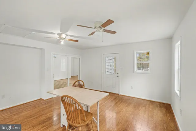 a bedroom with a bed and a ceiling fan