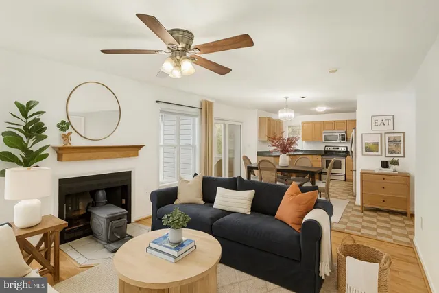 a living room with furniture a fireplace with kitchen view