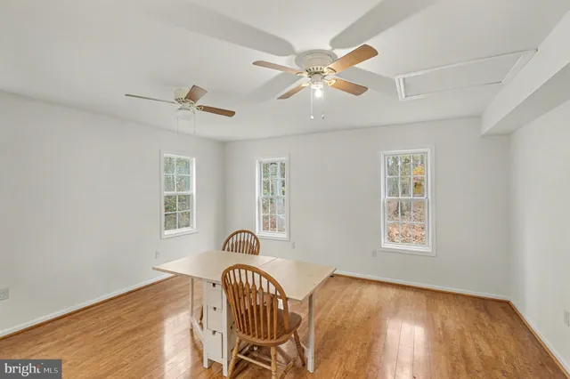 a view of a livingroom with furniture wooden floor and a window
