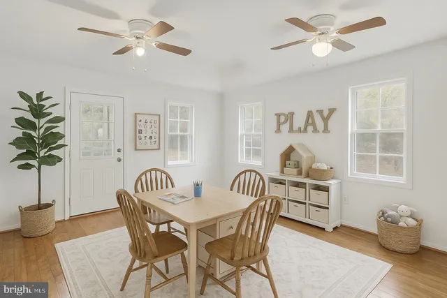 a view of a dining room with furniture window and wooden floor
