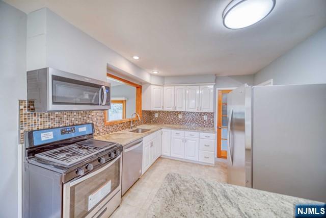 23 Smith Court Closter, NJ 07624 - Photo 12 of 23 a kitchen with a stove and a sink