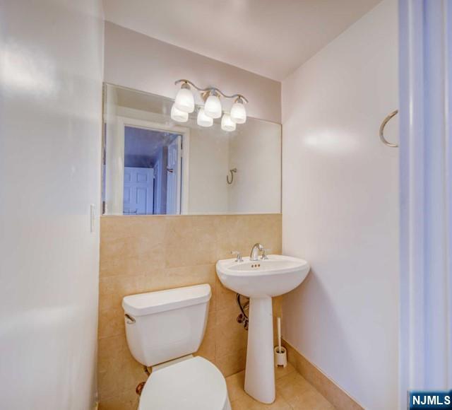 23 Smith Court Closter, NJ 07624 - Photo 16 of 23 a bathroom with a toilet sink and mirror
