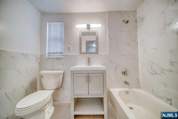 a bathroom with a toilet sink and bathtub