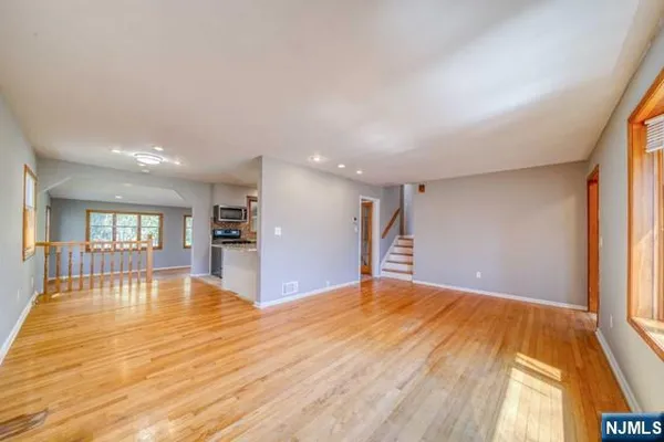 a large kitchen with stainless steel appliances granite countertop a refrigerator and a sink