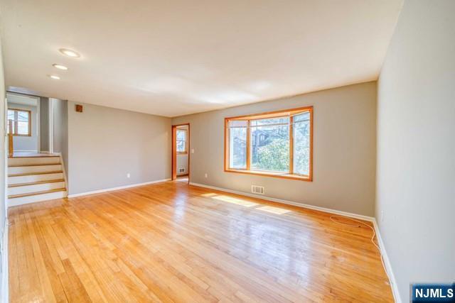 23 Smith Court Closter, NJ 07624 - Photo 9 of 23 a view of an empty room with wooden floor and a window