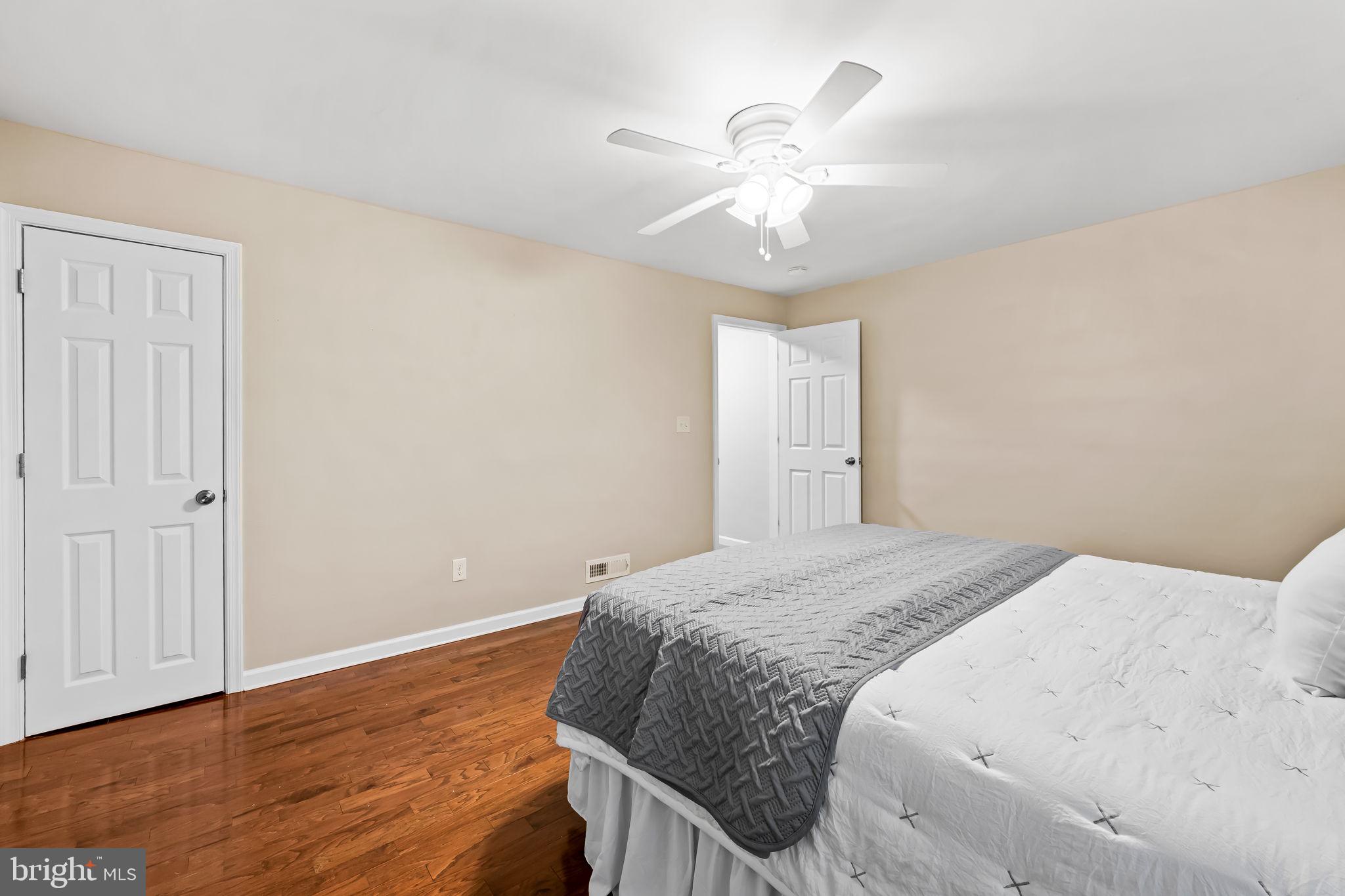 1817 Dunmere Road Baltimore, MD 21222 - Photo 21 of 27 a bedroom with a large bed and wooden floor