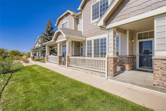a view of a white house with iron fence