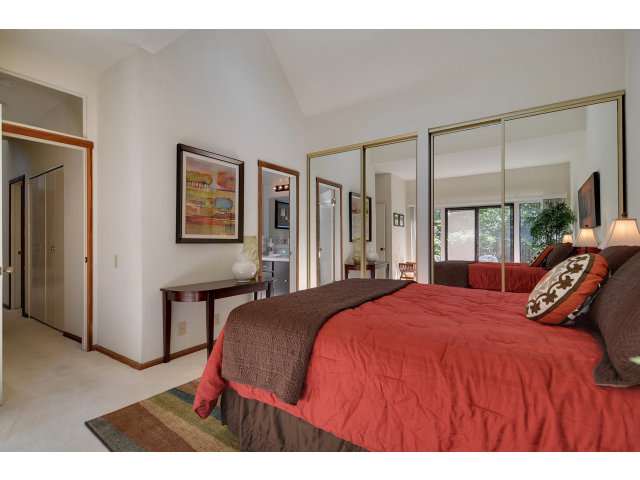 13 Farm Road Los Altos, CA 94024 - Photo 4 of 10 a bedroom with a large bed and a chandelier