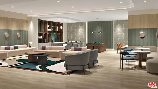 a living room with furniture a large window and wooden floor