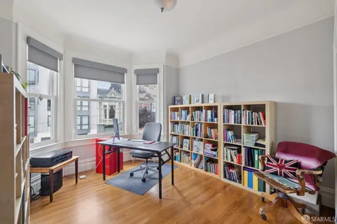 a living room with lots of furniture and book shelf