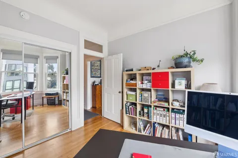a view of a dining room with furniture and wooden floor