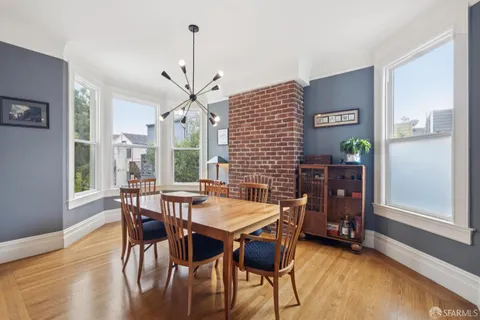 a view of a dining room with furniture window and wooden floor
