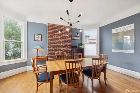 a kitchen with kitchen island stainless steel appliances a stove center island and a refrigerator