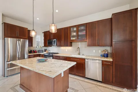a kitchen with sink refrigerator and cabinets